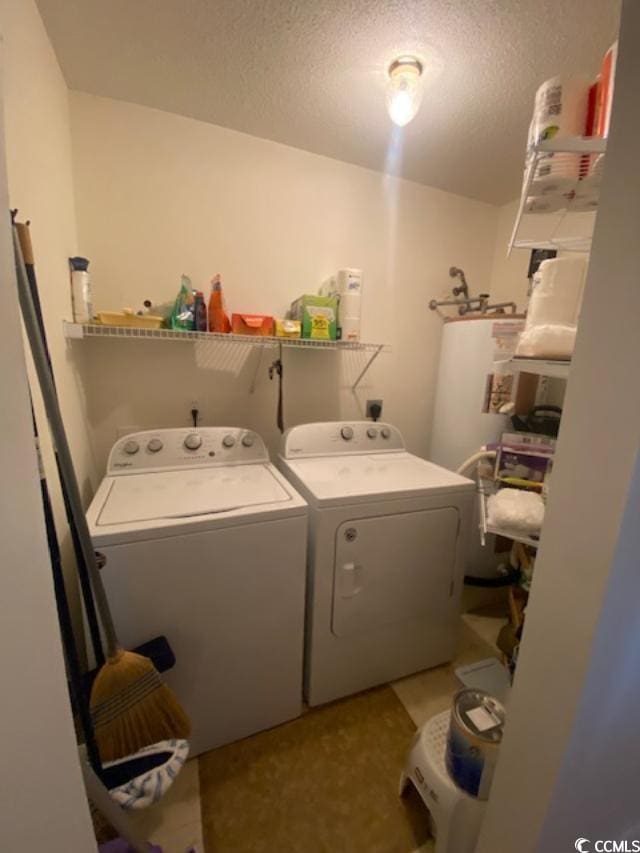 8650 Southbridge Dr Unit A, Surfside Beach, SC 29575 - laundry area featuring washing machine and clothes dryer, a textured ceiling, and gas water heater