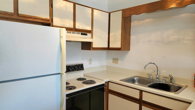 kitchen with range with electric cooktop, sink, white refrigerator, and white cabinetry