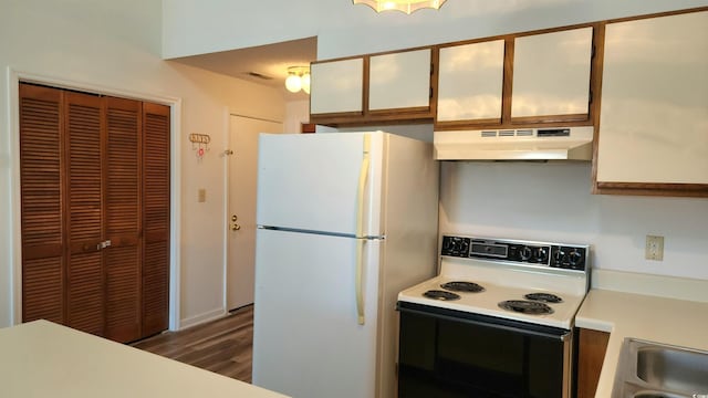 kitchen with dark hardwood / wood-style floors, electric range, sink, white cabinets, and white refrigerator