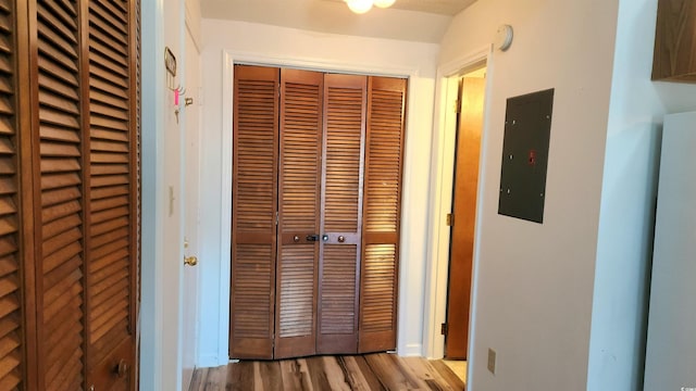 hall featuring light wood-type flooring and electric panel