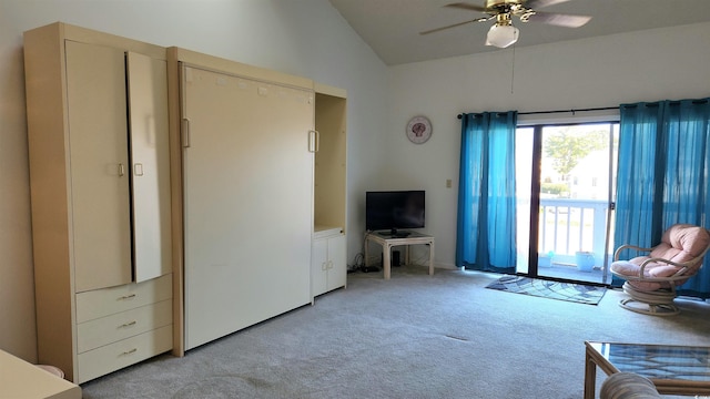 carpeted living room with ceiling fan and lofted ceiling