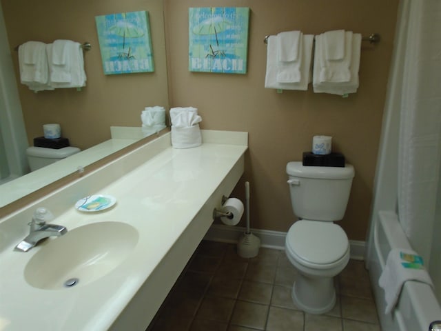 bathroom featuring tile patterned flooring, toilet, vanity, baseboards, and radiator heating unit