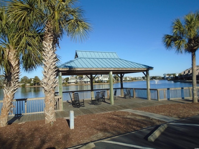 view of dock with a gazebo and a water view