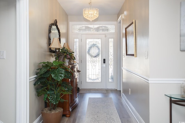 entryway featuring dark hardwood / wood-style flooring and a chandelier