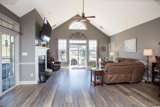 living room featuring ceiling fan, hardwood / wood-style floors, and lofted ceiling