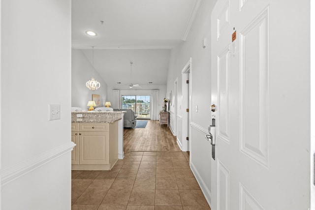 hall featuring tile patterned flooring and crown molding