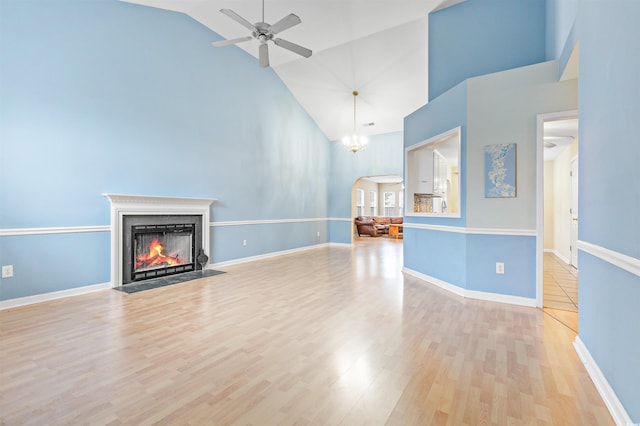 unfurnished living room featuring high vaulted ceiling, light wood-type flooring, and ceiling fan