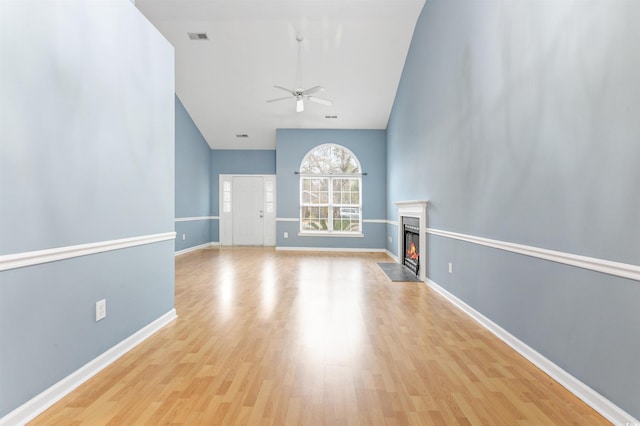 unfurnished living room with ceiling fan and light hardwood / wood-style flooring