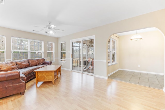 living room with light wood-type flooring and ceiling fan