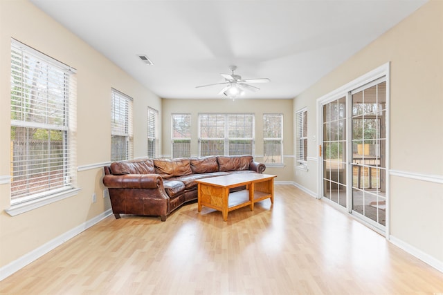 living room with ceiling fan and light hardwood / wood-style flooring