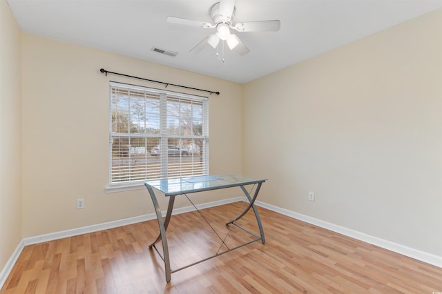 unfurnished office with ceiling fan and light hardwood / wood-style flooring