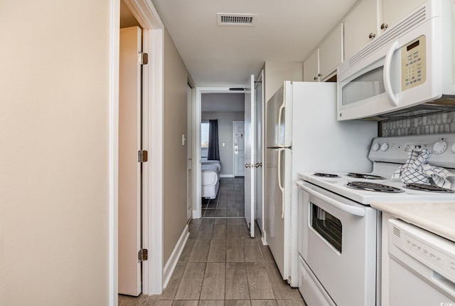 kitchen with white appliances and white cabinets