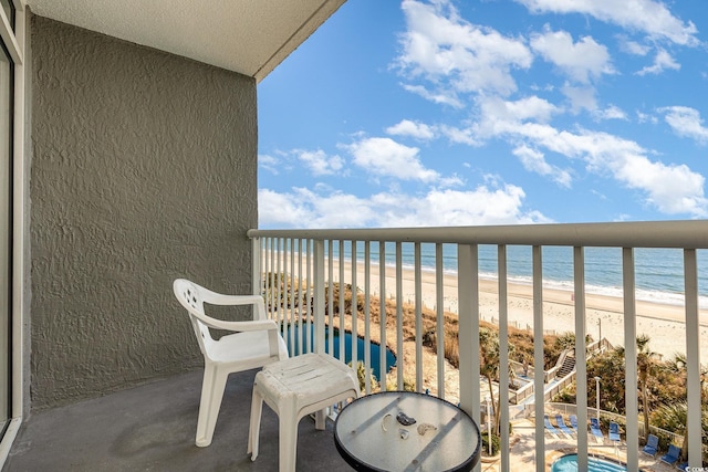 balcony with a beach view and a water view