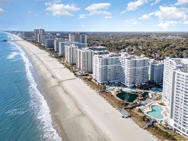 drone / aerial view with a water view and a beach view