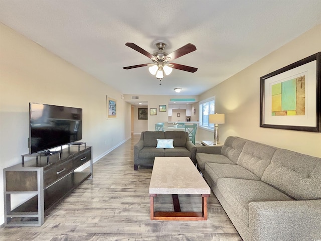 living room with ceiling fan and hardwood / wood-style floors