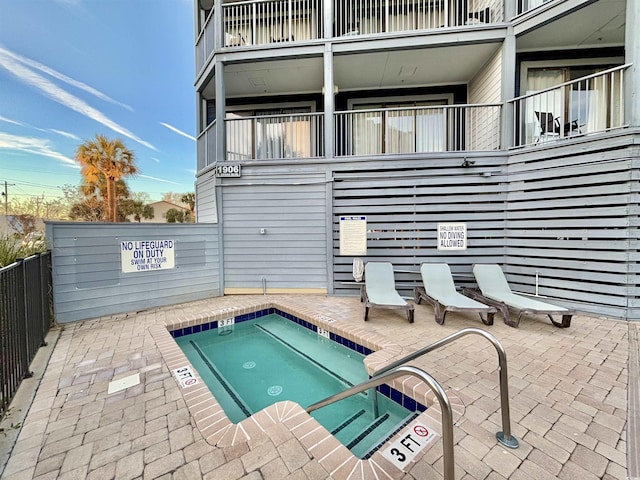 view of pool with a community hot tub and a patio