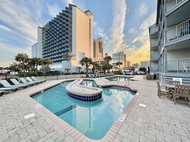 view of pool with a jacuzzi and a patio