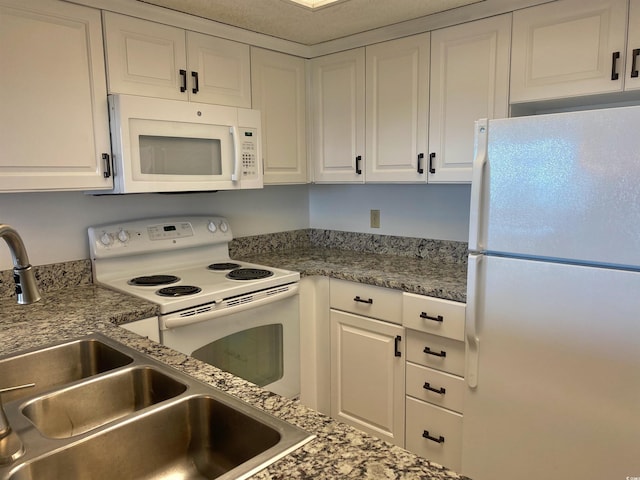 kitchen with white cabinetry, sink, and white appliances