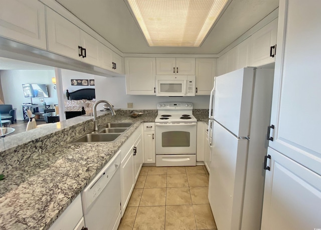 kitchen featuring light tile patterned flooring, white cabinetry, sink, and white appliances