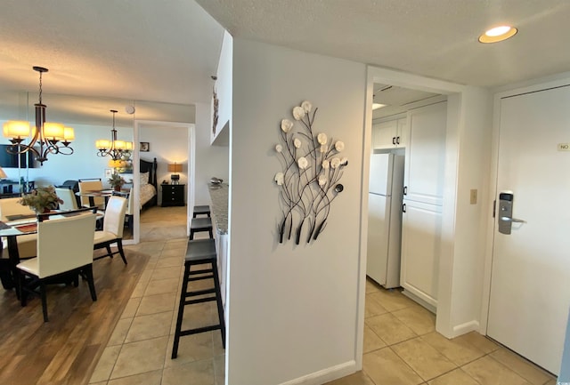 interior space featuring light tile patterned flooring and a chandelier