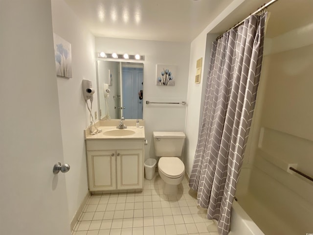 full bathroom featuring shower / bath combo with shower curtain, toilet, vanity, and tile patterned flooring