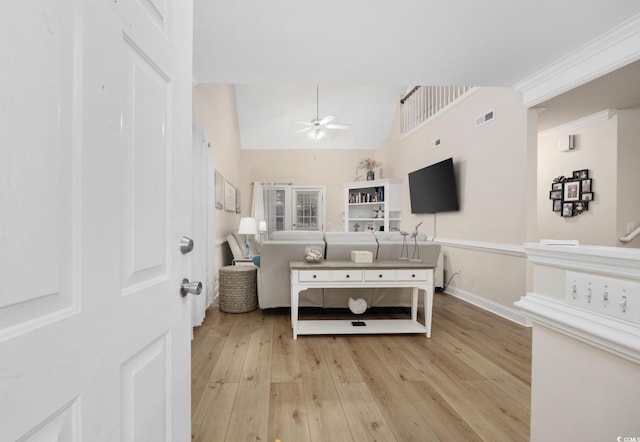 bathroom with lofted ceiling, wood-type flooring, ornamental molding, and ceiling fan