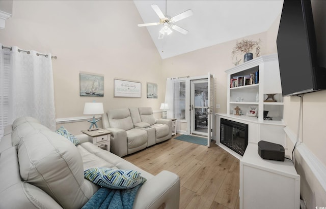 living room with high vaulted ceiling, light hardwood / wood-style floors, and ceiling fan