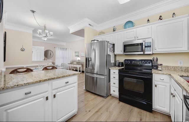 kitchen with appliances with stainless steel finishes, white cabinetry, ornamental molding, light stone counters, and light wood-type flooring