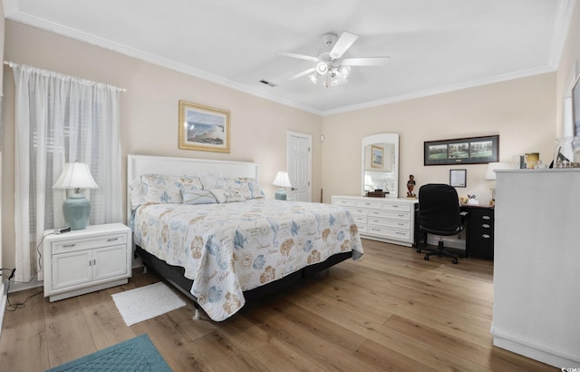 bedroom featuring ornamental molding, light hardwood / wood-style floors, and ceiling fan