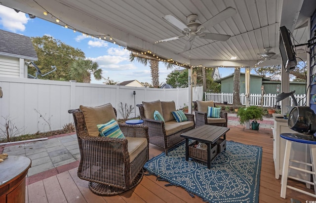 deck with outdoor lounge area and ceiling fan