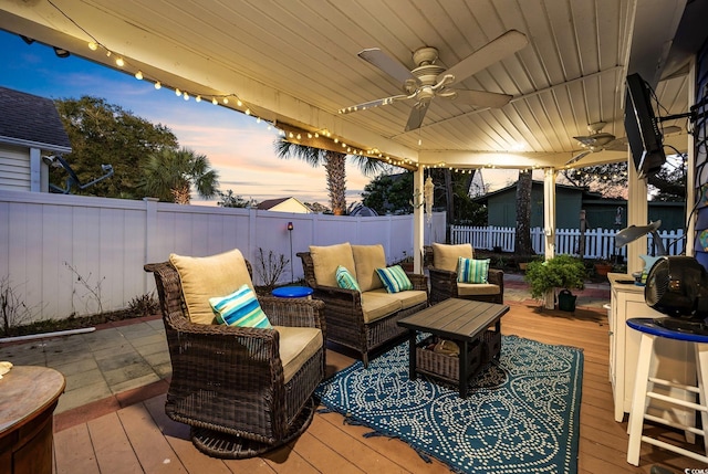 wooden terrace with ceiling fan and outdoor lounge area