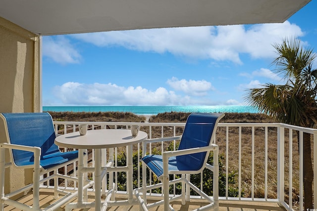 balcony with a water view and a beach view