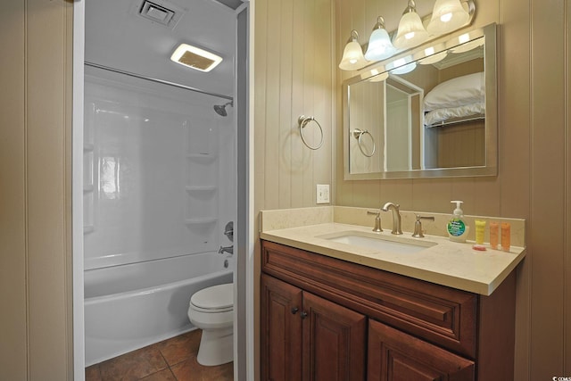 full bathroom featuring toilet, wood walls, shower / washtub combination, vanity, and tile patterned flooring