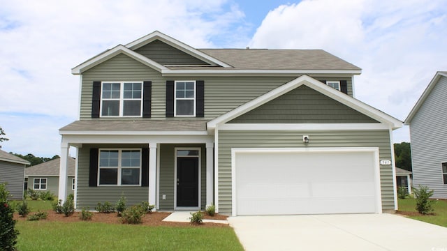 craftsman-style house featuring a front yard and a garage