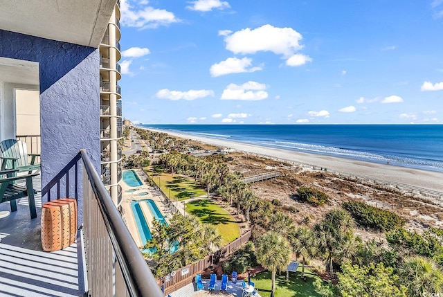 balcony with a water view and a beach view