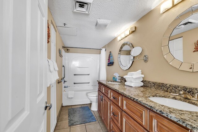 full bathroom featuring toilet, shower / tub combo with curtain, tile patterned floors, a textured ceiling, and vanity