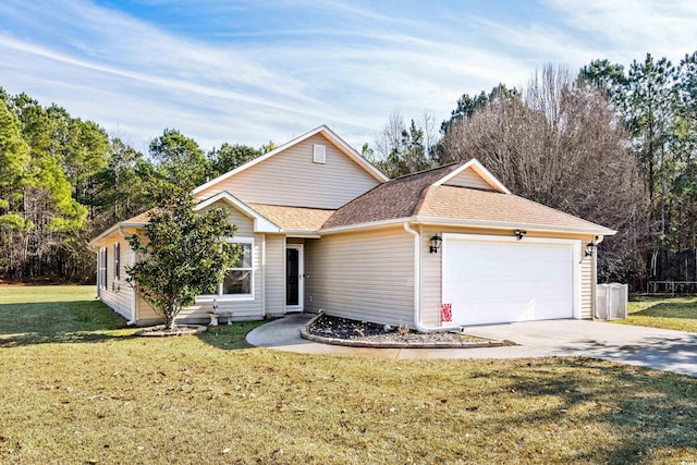 view of front of home with a front lawn and a garage