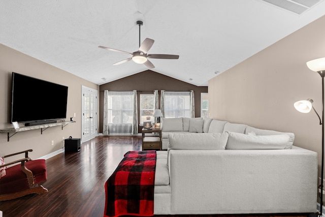 living room featuring lofted ceiling, ceiling fan, and dark wood-type flooring