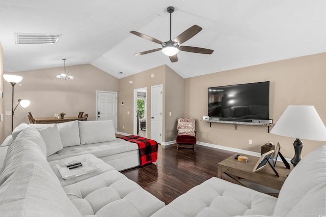 living room with ceiling fan with notable chandelier, dark hardwood / wood-style floors, and vaulted ceiling