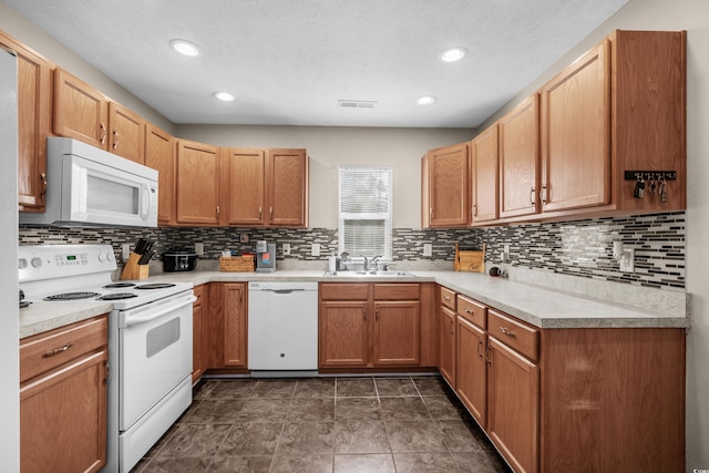 kitchen with sink, tasteful backsplash, and white appliances