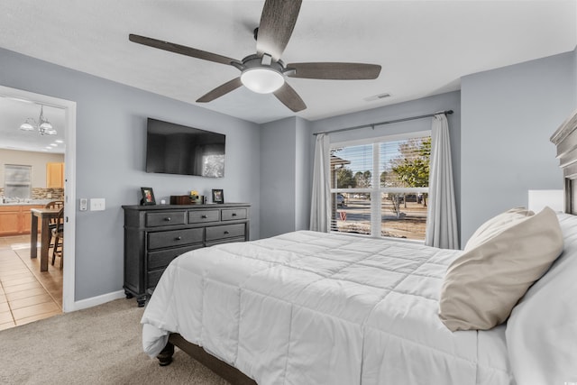 bedroom featuring light carpet and ceiling fan