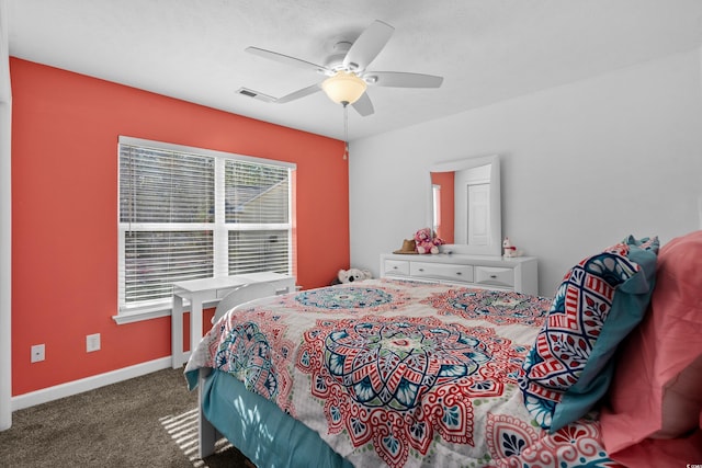 bedroom with ceiling fan and dark colored carpet