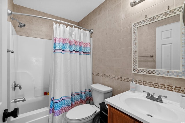 full bathroom featuring toilet, vanity, tile walls, and shower / bath combo