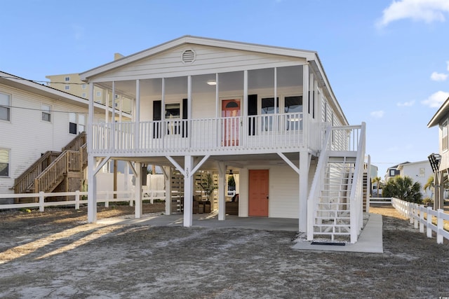 coastal inspired home featuring a porch and a carport