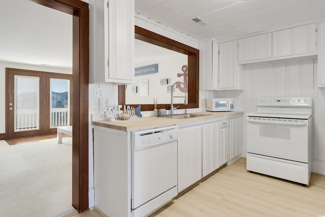 kitchen featuring sink, light hardwood / wood-style flooring, white cabinets, and white appliances