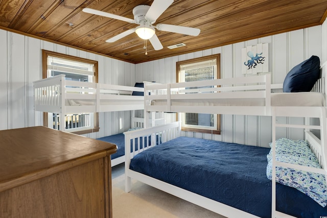 carpeted bedroom with ceiling fan and wood ceiling