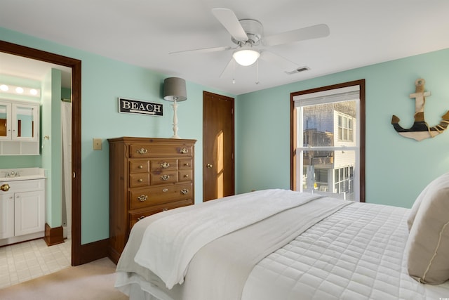 bedroom featuring ensuite bathroom and ceiling fan