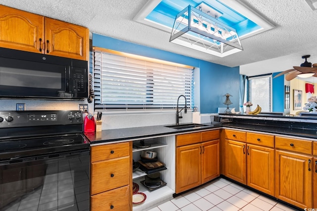 kitchen featuring a textured ceiling, ceiling fan, sink, and black appliances