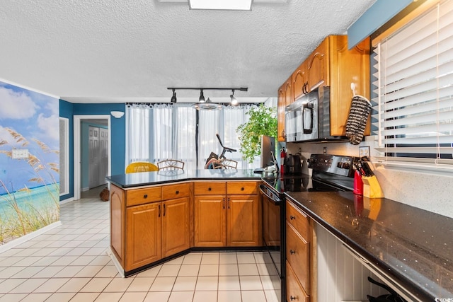 kitchen with kitchen peninsula, black range with electric stovetop, a textured ceiling, light tile patterned floors, and rail lighting