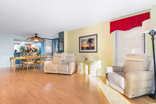 living room with ceiling fan and hardwood / wood-style floors